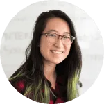 Profile photo of a smiling woman with glasses and dark hair.